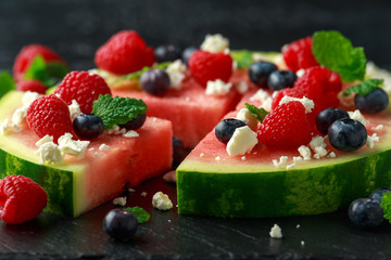 Juicy watermelon pizza with blueberries, raspberry feta cheese, mint. party food