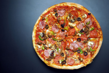 round bright pizza on a dark background