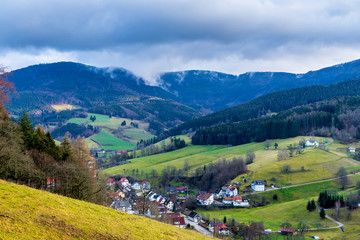 Fototapeta na wymiar Germany, Impressive black forest covered mountains and small village houses