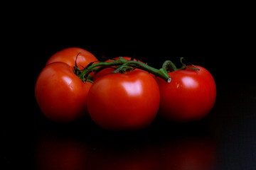 fresh tomatoes on black background