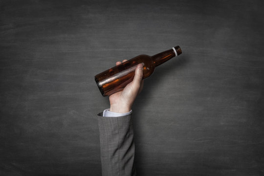 Businessman holding beer bottle