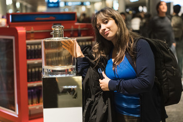 young woman in clothing store perfum big happy smile face portrait discover traveler buying