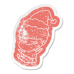 cartoon distressed sticker of a boy wearing santa hat