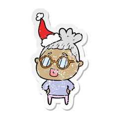 distressed sticker cartoon of a librarian woman wearing spectacles wearing santa hat