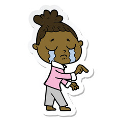 sticker of a cartoon crying woman pointing