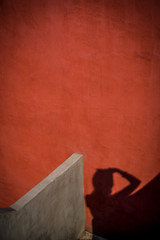 Fototapeta na wymiar Red wall and shadow of photographer, San Angel, Mexico City, Mexico