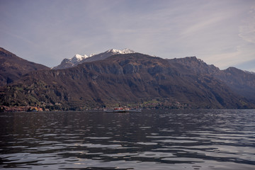 Italy, Menaggio, Lake Como, a body of water with a mountain in the background