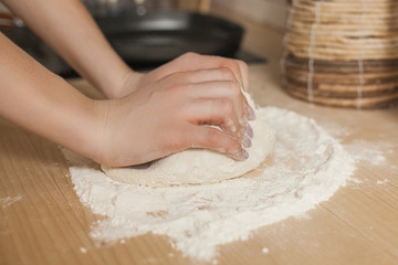 Woman making dough. Female cooking. Chef making pastry. Closeup woman`s hands with flour and the dough.