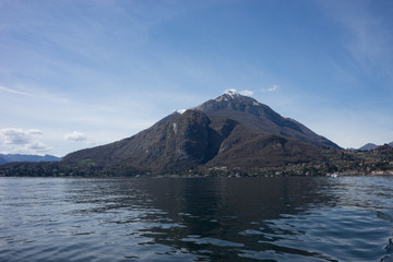 Italy, Menaggio, Lake Como, a body of water with a mountain in the background