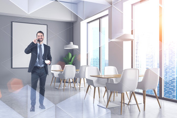 Smiling businessman with coffee in cafe