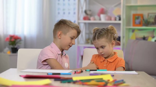 Playful brother touching sisters nose, children communication, apologizing