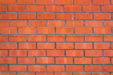 Fototapeta premium Wall of red facing brick background.