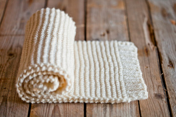 Fototapeta na wymiar Hand knitted white scarf
