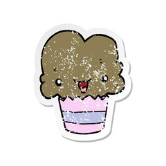 distressed sticker of a cartoon cupcake with face