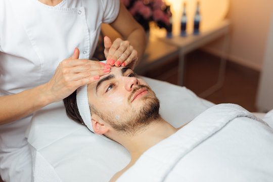 Unshaven man having cosmetic mask care in spa salon, side, top view - Image