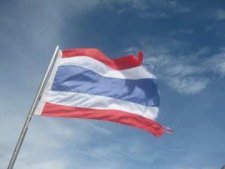 Thailand flag blowing against blue sky red blue white stripe flag