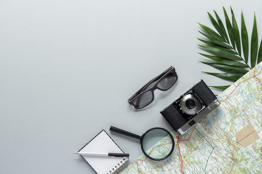 Palm Leaf Sunglasses Lens Photo Camera Notepad Pen Beach Road Map  Top View With Copy Space For Your Text. Flat Lay. 