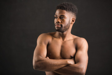 Fototapeta na wymiar handsome african man with muscles on black background