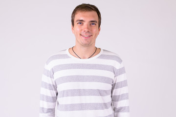 Fototapeta premium Portrait of happy man smiling against white background