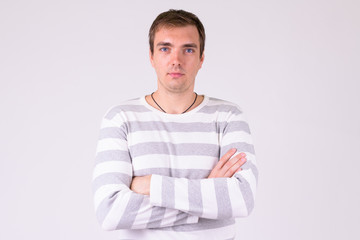 Portrait of man with arms crossed against white background