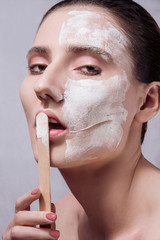 Woman spa mask half-face beauty concept. Close up portrait, stick for mask