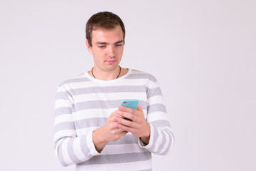 Portrait of man using phone against white background