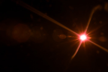 abstract lens flare red light over black background