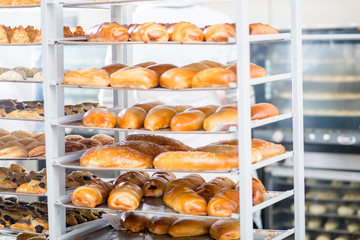 racks with finished and raw dough products in a bakery