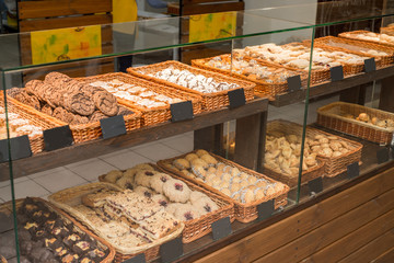 bakery products on display against the background of ovens in the bakery
