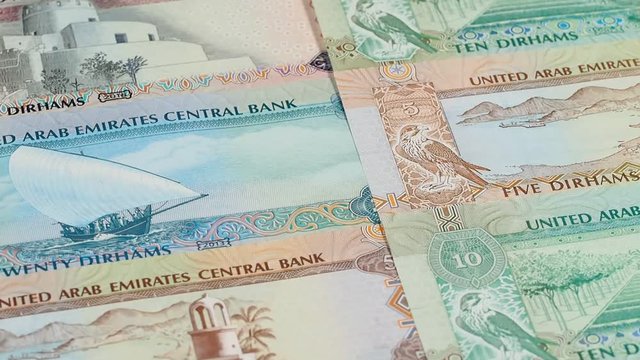 UAE dirham notes slow rotating. Emirates money currency. Low angle. Stock video footage