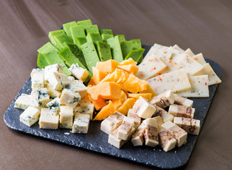 Different types of cheese on a plate. Cheese Snacks to Wine