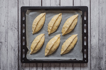 Pies on a baking sheet before baking. Top view. 