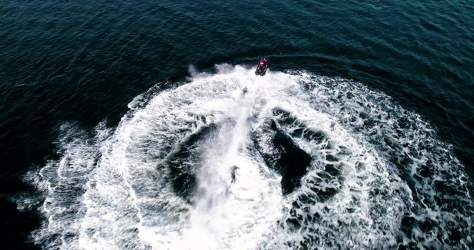 jetski having lots of fun in the fjords of Norway, located in Langesund- Jetski doing circles, from above, drone footage.