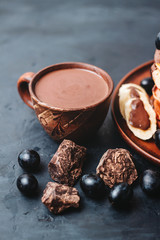 Cup of sweet hot chocolate drink on dark background