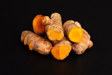 Curcuma turmeric roots on black background