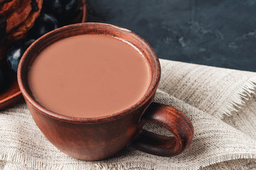 Cup of sweet hot chocolate drink on dark background