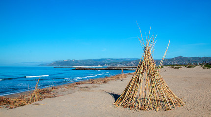 Fototapeta na wymiar Bamboo teepee on Surfers Knoll beach at McGrath State Park in Ventura California United States