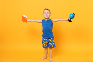 Kid boy 3-4 years old in blue beach summer clothes hold globe passport isolated on bright yellow orange wall background children studio portrait. People childhood lifestyle concept Mock up copy space.