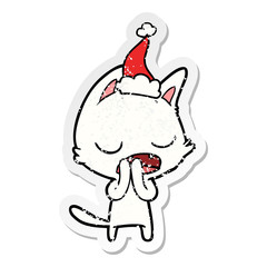 talking cat distressed sticker cartoon of a wearing santa hat