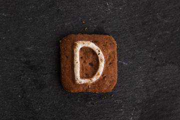 cookie letters on black stone background