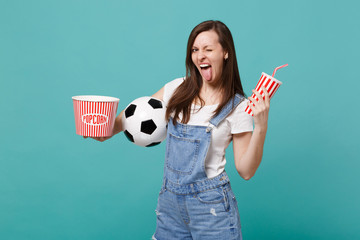 Funny woman football fan watching match, support favorite team with soccer ball, bucket of popcorn,...