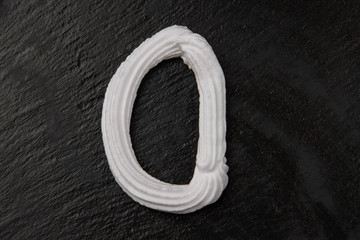 The letters of the English alphabet written in white cream