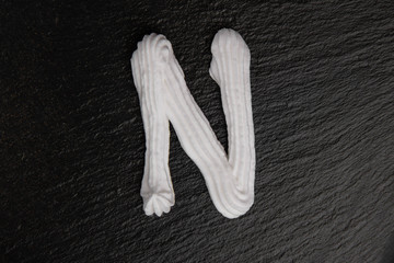 The letters of the English alphabet written in white cream