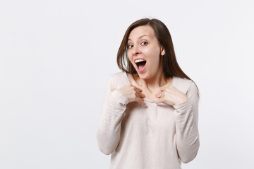 Portrait of surprised amazed young woman in light clothes keeping mouth open pointing hands on herself isolated on white wall background. People sincere emotions lifestyle concept. Mock up copy space.