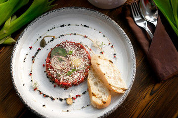 Beef Tartar with croutons on white plate, molecular Haute cuisine
