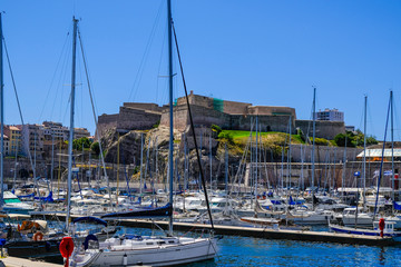 MARSEILLE, FRANCE - AUGUST 11, 2018 - Marseille embankment with yachts and boats in the Old Port and Fort Saint-Nicolas. Vieux-Port de Marseille.
