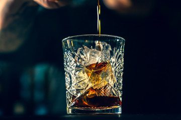 black Russian cocktail. The bartender prepares it in a glass of ice.
