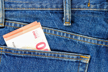 Several bills of ten euros in the back pocket of jeans. Concept of absentminded person, potential victim of theft.