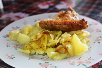 fried potatoes with chicken wings grill
