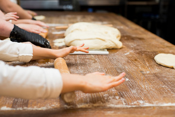 Young children make dough products. Hands closeup